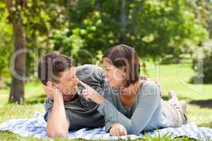 Couple lying down in the park