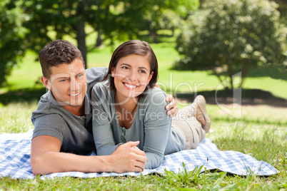 Couple lying down in the park