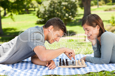 Couple playing chess in the park