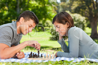 Couple playing chess in the park