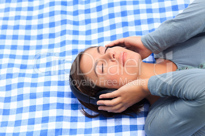 Woman listening to some music in the park