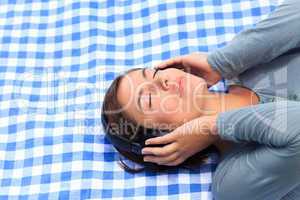 Woman listening to some music in the park