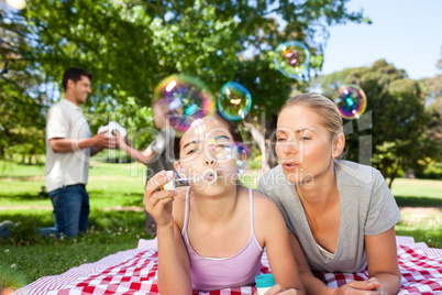 Mother and daughter having fun in the park