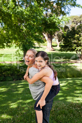 Daughter playing with her young mother