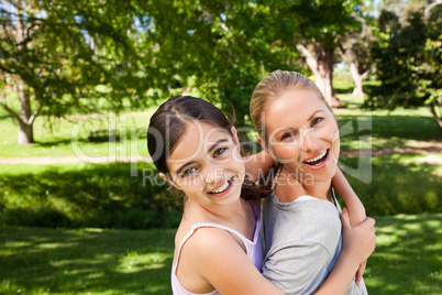 Daughter playing with her young mother