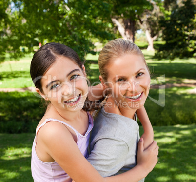 Mother and her daughter laughting in the park