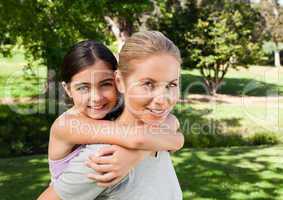 Mother and her daughter laughting in the park