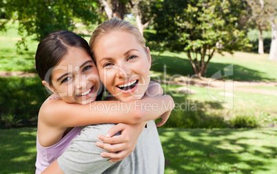 Mother and her daughter laughting in the park