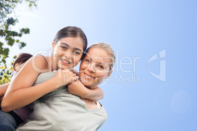 Mother and her daughter laughting in the park