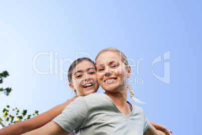 Mother and her daughter laughting in the park