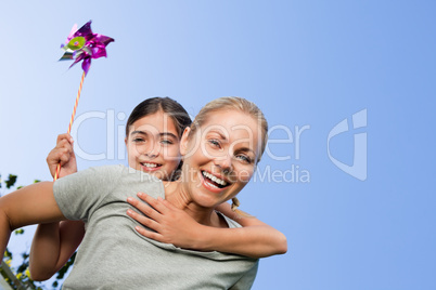 Mother and her daughter with a windmill