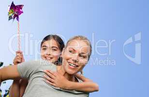 Mother and her daughter with a windmill