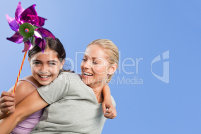 Mother and her daughter with a windmill