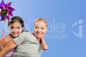 Mother and her daughter with a windmill