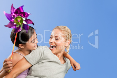 Mother and her daughter with a windmill