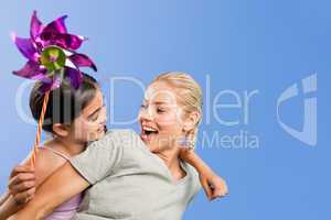 Mother and her daughter with a windmill