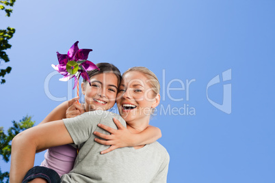 Mother and her daughter with a windmill