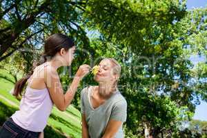 Mother and her daughter with a flower