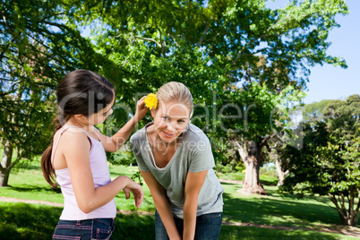 Mother and her daughter with a flower