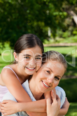 Cute daughter with her mother in the park