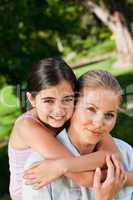 Cute daughter with her mother in the park