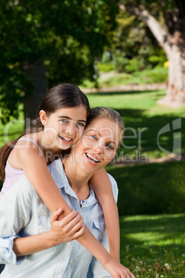 Cute daughter with her mother in the park