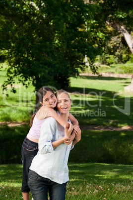 Mother having daughter a piggyback