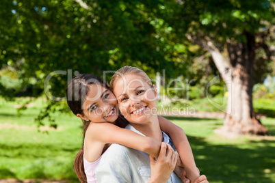 Mother having daughter a piggyback