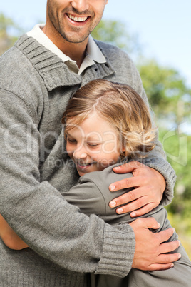 Son embracing his father