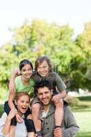 Parents giving children a piggyback