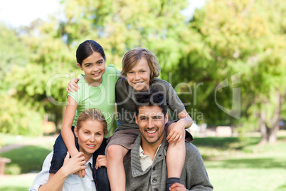 Parents giving children a piggyback