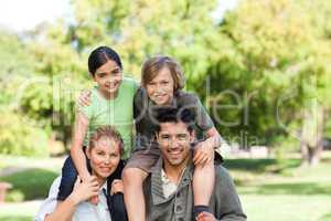 Parents giving children a piggyback