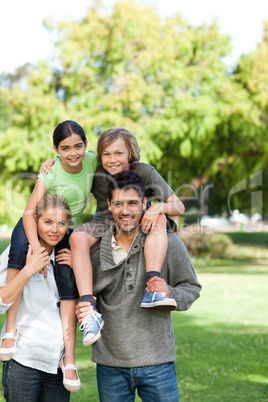 Parents giving children a piggyback