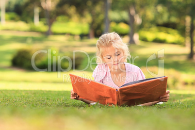 Little girl looking at her album photo