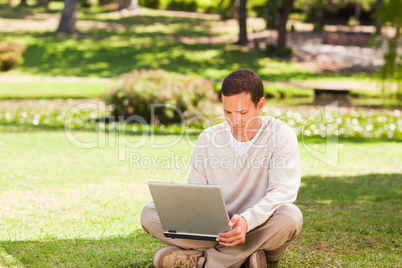Man working on his laptop in the park