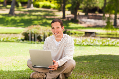 Man working on his laptop in the park