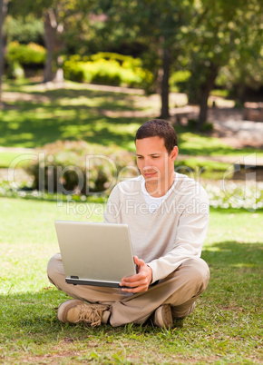 Man working on his laptop in the park