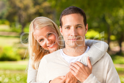 Woman hugging her boyfriend in the park