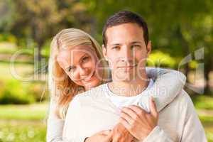 Woman hugging her boyfriend in the park