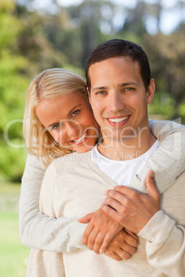 Woman hugging her boyfriend in the park