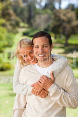 Woman hugging her boyfriend in the park