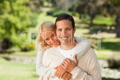 Woman hugging her boyfriend in the park