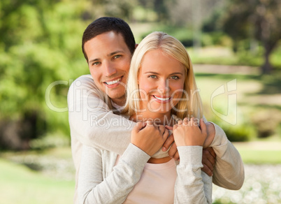 Woman hugging her boyfriend in the park