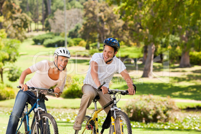 Couple with their bikes in the park