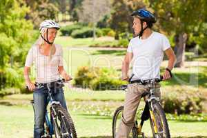 Couple with their bikes in the park