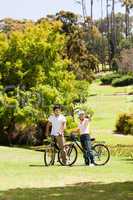 Couple with their bikes in the park
