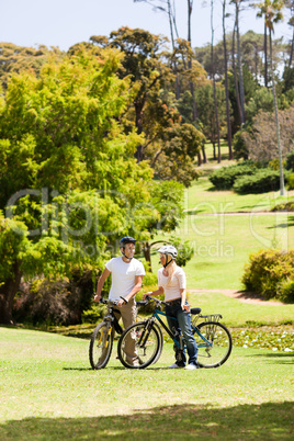 Couple with their bikes in the park