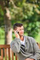 Man phoning on the bench