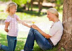 Daughter offering a flower to her mother