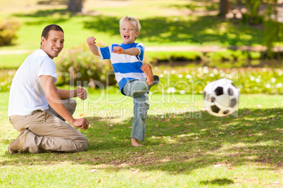 Father playing football with his son